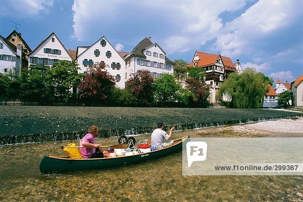 Two people boating in river  Danube River  Swabian Jura  Baden-Wurttemberg  Germany