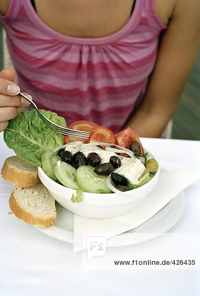 Eine Frau Essen griechischen Salat.
