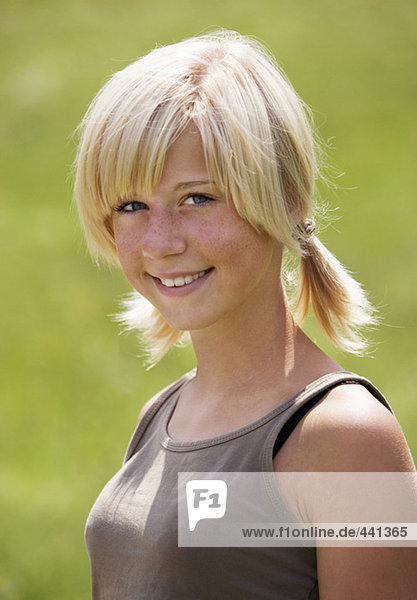Teenage girl (13-15) smiling  portrait  close-up