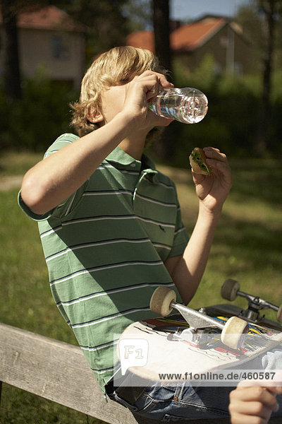 Boy drinking out of a bottle.