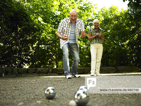 Senior citizen playing boule.