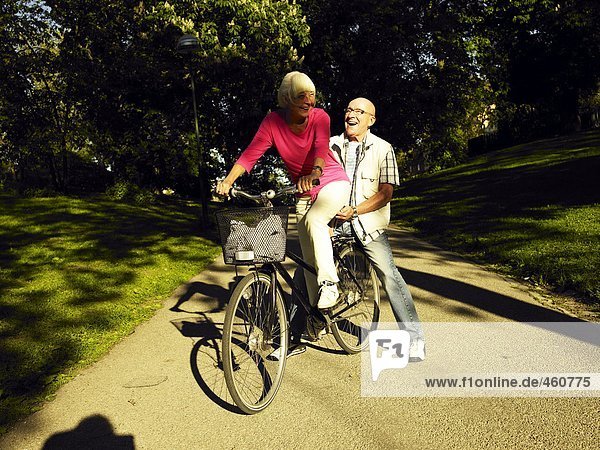 A couple on a bicycle.