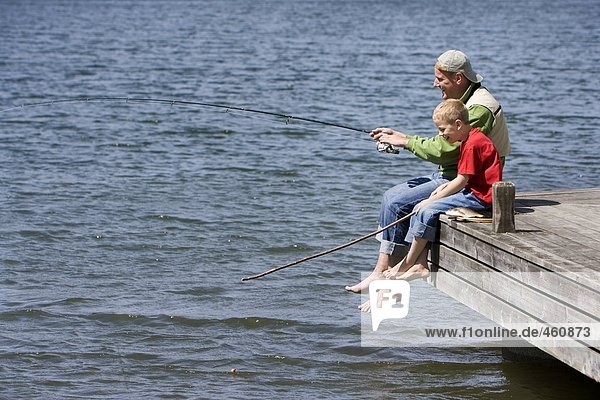 Father and son fishing together.