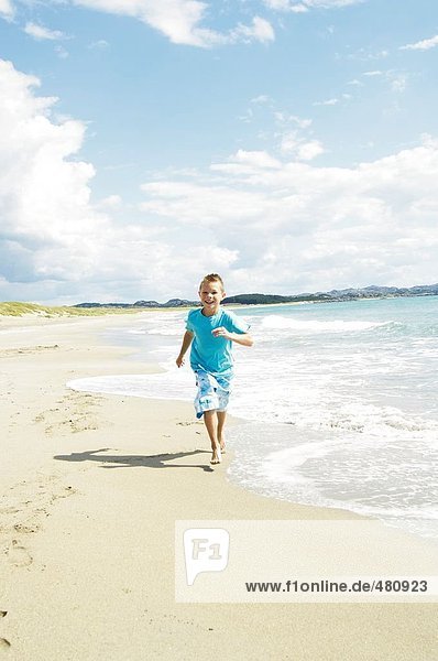 Boy running on beach