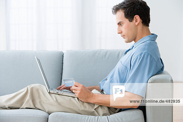 Man using a laptop computer at home
