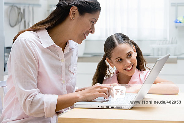 Mother and daughter using a laptop computer