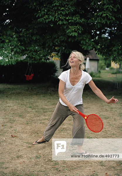 Woman playing beach tennis.