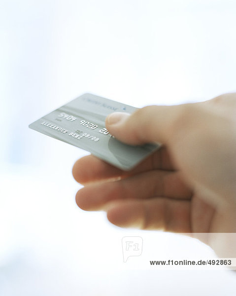 A credit card in a hand.