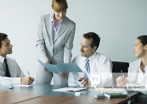 Businesswoman showing file in meeting