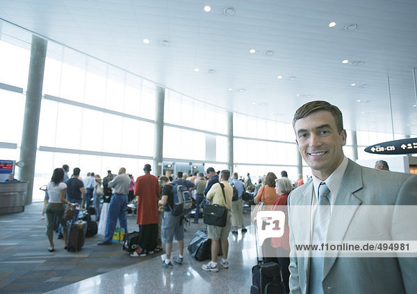 Businessman standing in airport boarding area