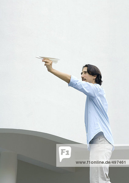 Man standing  aiming paper airplane