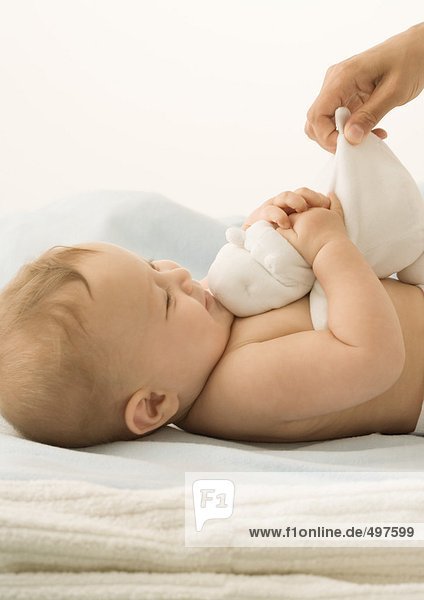 Baby playing with stuffed animal