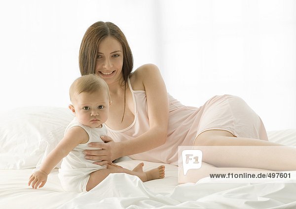 Mother and baby on bed