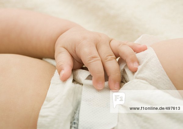 Baby's hand on diaper
