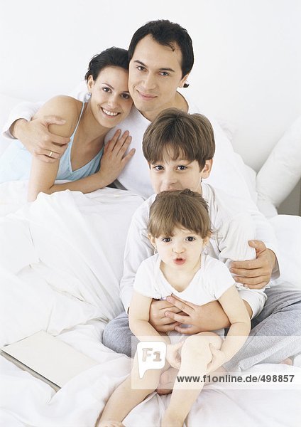 Family in bed together