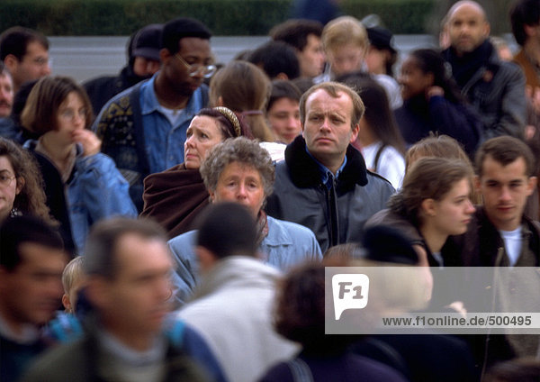 Crowd  focus on man in middle ground