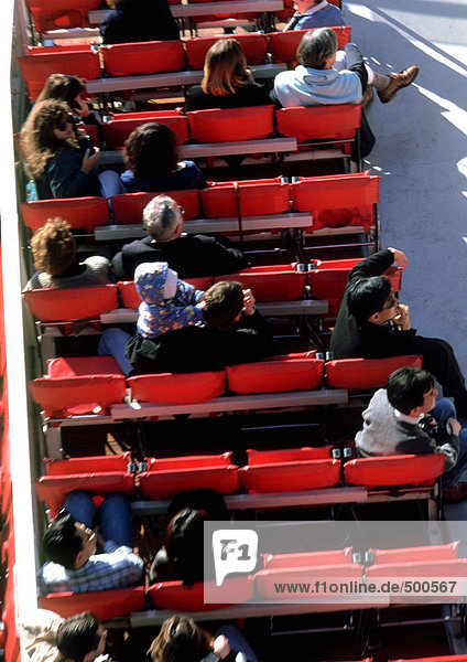 People sitting in fold-down chairs  high angle view