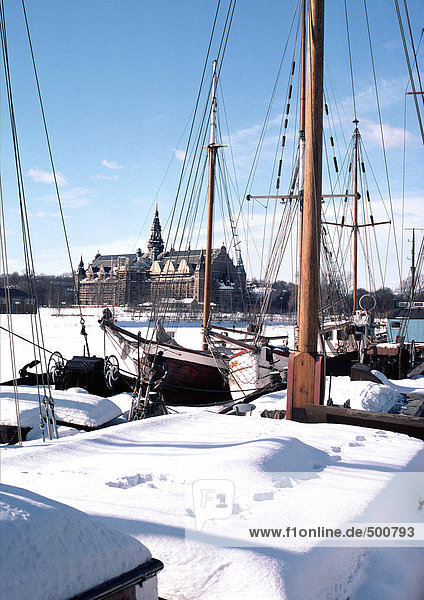 Sweden  Stockholm  boats in foreground  church in distance  under snow