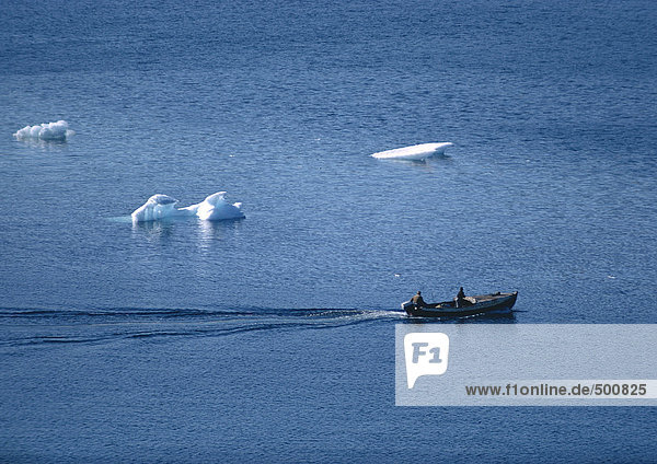 Greenland  boat in sea with icebergs