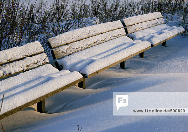 Sweden  park benches covered with snow