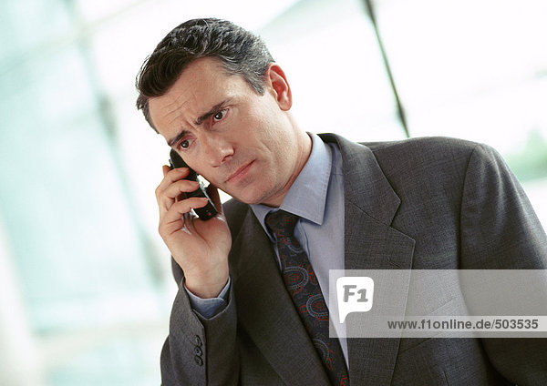 Businessman holding cell phone  portrait
