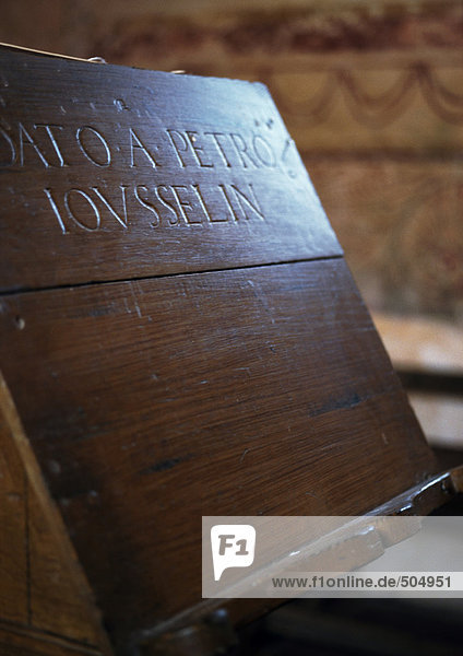 Latin inscription engraved in wood lectern  close-up