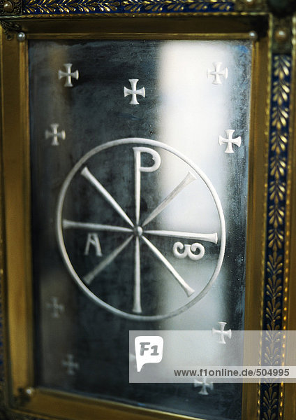 Christian monogram engraved in metal