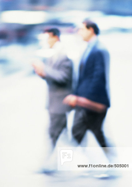 Businessmen walking  blurred