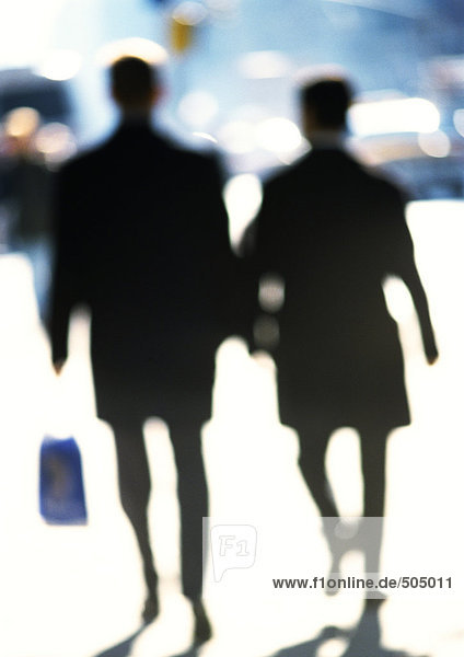 Silhouettes of women in street  blurred