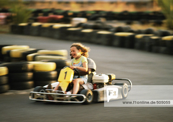 Two people go-carting  blurred motion
