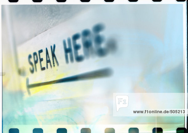'Arrow and ''speak here'' text  close-up'