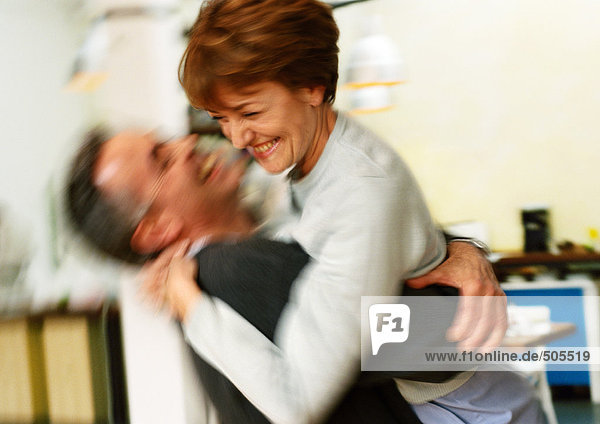 Man holding woman in arms  blurred