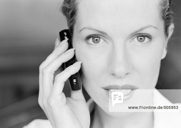 Businesswoman using cellular phone  close-up  black and white.