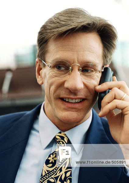 Businessman using cellular phone  front view  close-up  portrait.