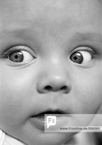 Baby's face  looking to the side  close-up  B&W.