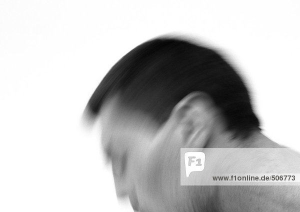 Man's head in motion,  side view,  close-up,  blurred,  black and white.