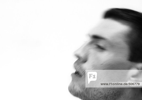 Man's face,  side view,  blurred,  close-up,  black and white.