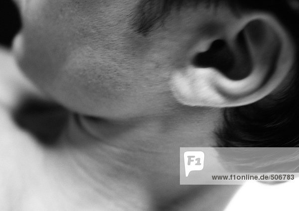 Man's ear and neck  close up  black and white.