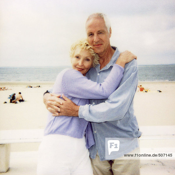 Mature couple embracing at the beach  portrait  soft focus