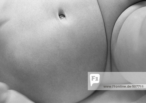Baby's belly and thigh  close-up  b&w