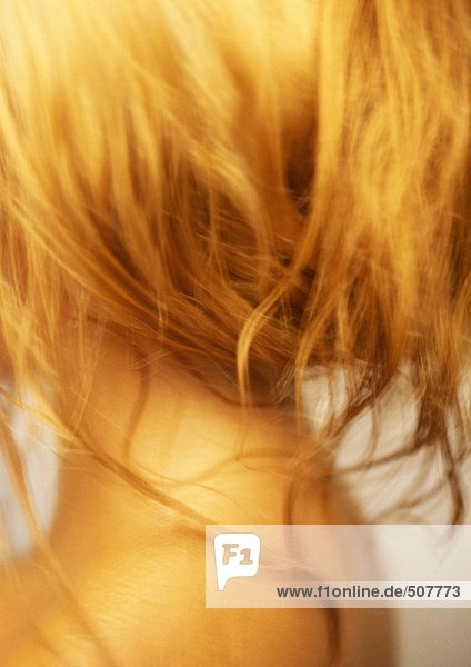 Woman with wet hair on neck and shoulder  close-up  rear view