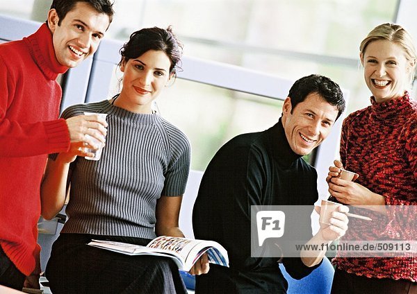 Four people holding plastic cups  portrait