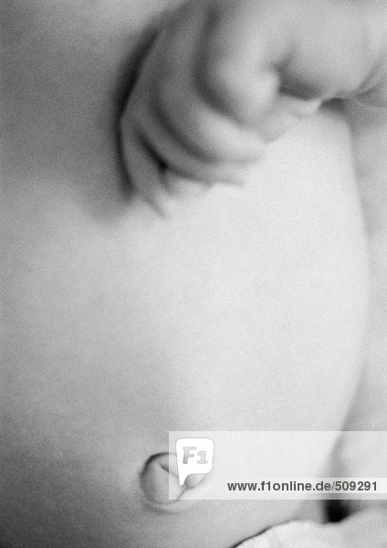Baby's belly and hand  close-up  b&w