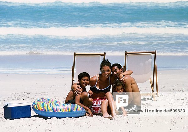 Familie posiert für Foto am Strand