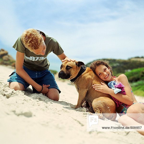 Children with dog on the beach