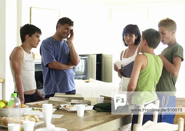 Family standing around table