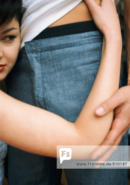 Woman holding man around waist  close-up