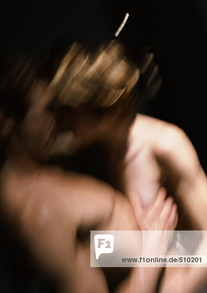 Nude couple embracing  blurred motion