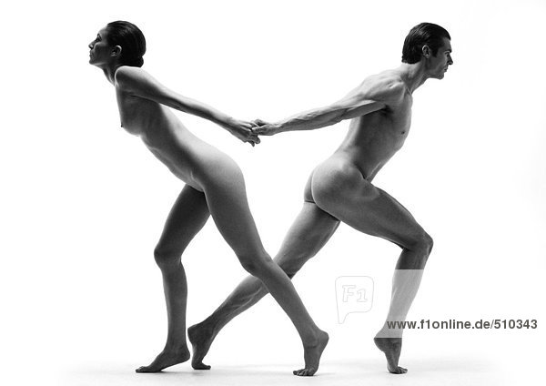 Nude man and woman back to back  stepping away from each other  holding hands  b&w