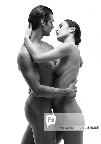 Nude man and woman standing  embracing each other  b&w